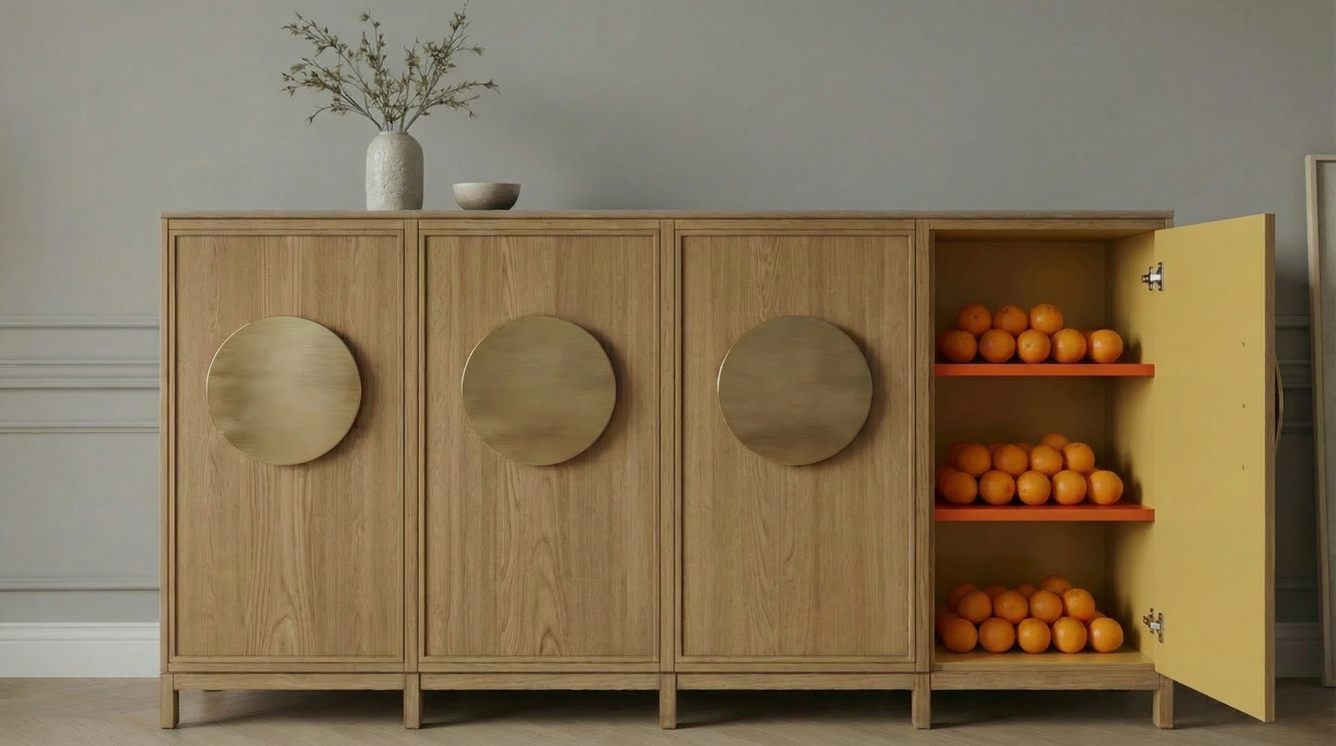 Close-up detail of the oak sideboard frame and brass circular pulls